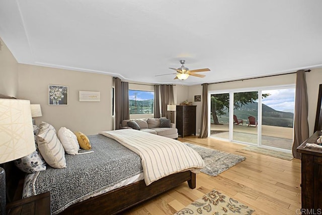 bedroom with access to outside, ceiling fan, and light wood-type flooring