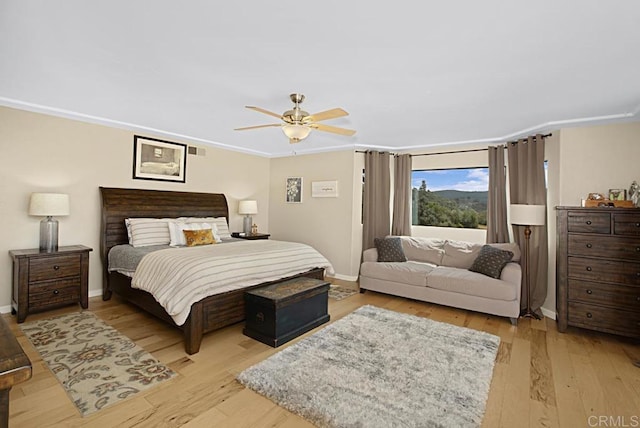 bedroom with ceiling fan and light hardwood / wood-style floors