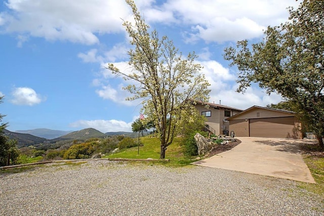 view of front of property with an outbuilding, a garage, and a mountain view