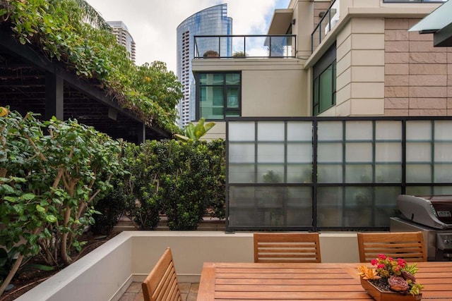 view of patio with a balcony and area for grilling