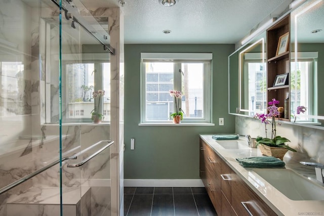 bathroom with vanity, a textured ceiling, and an enclosed shower