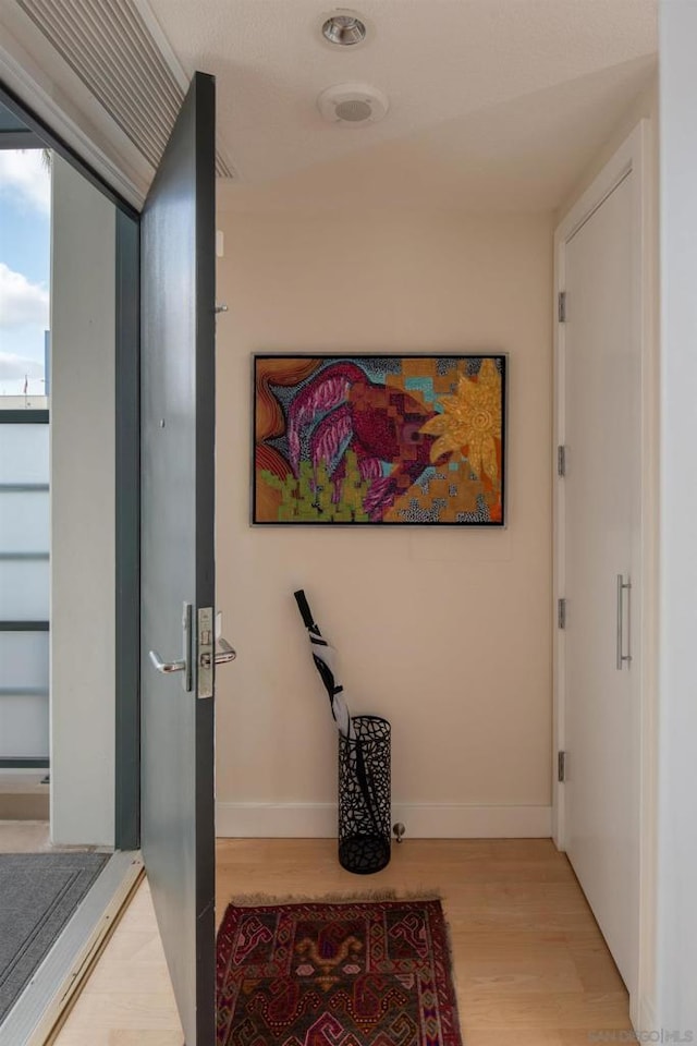 corridor featuring light hardwood / wood-style floors