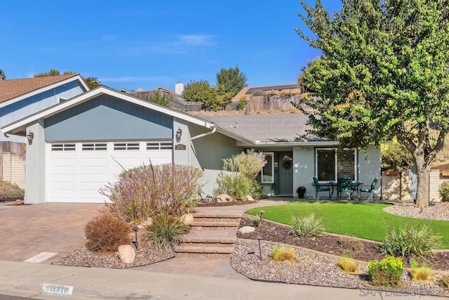 ranch-style house with a garage and a front lawn