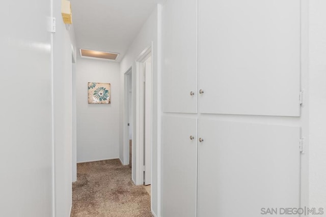 hallway featuring light colored carpet