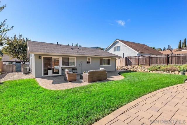 rear view of house with cooling unit, an outdoor living space, a yard, and a patio area