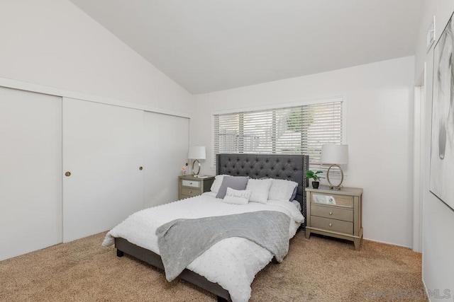 carpeted bedroom with lofted ceiling