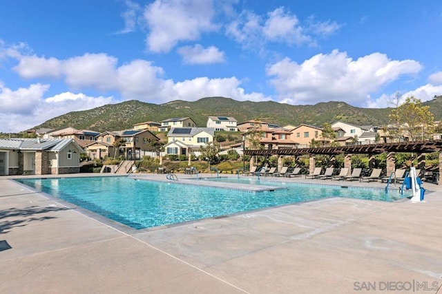 view of swimming pool featuring a mountain view and a patio