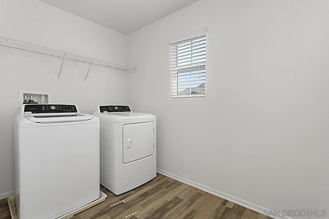 laundry room with dark hardwood / wood-style flooring and independent washer and dryer