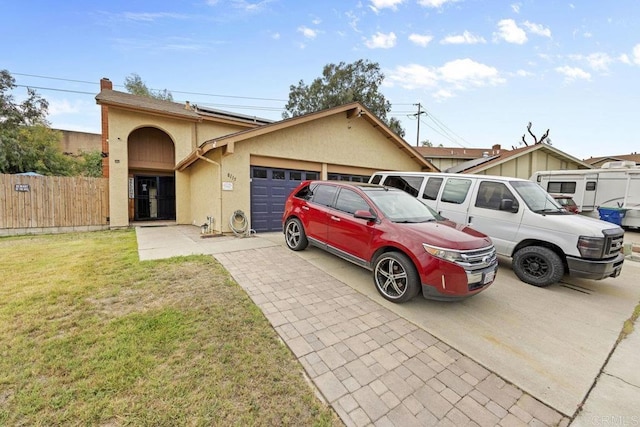 8115 Cacus, Spring Valley, CA 91977 - view of front facade featuring stucco siding, a garage, driveway, and a chimney