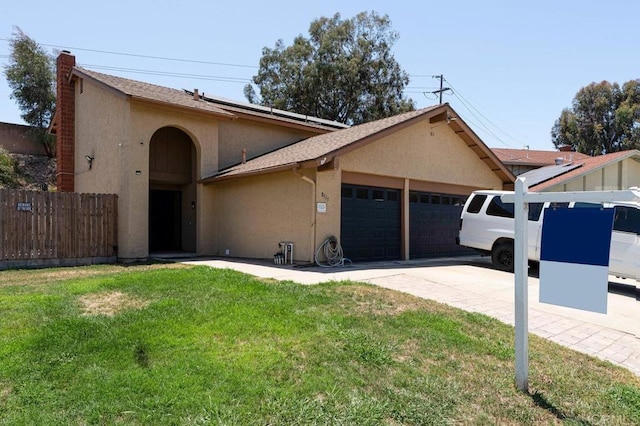 8115 Cacus, Spring Valley, CA 91977 - view of front of property featuring a garage, stucco siding, roof mounted solar panels, concrete driveway, and a chimney