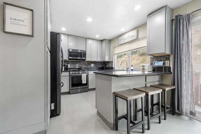 8115 Cacus, Spring Valley, CA 91977 - kitchen featuring appliances with stainless steel finishes, a peninsula, backsplash, dark countertops, and recessed lighting