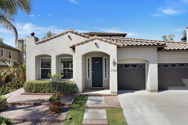 mediterranean / spanish-style home featuring a garage