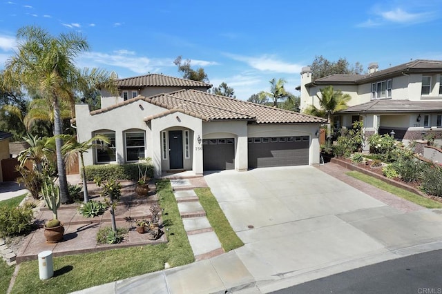 mediterranean / spanish home with a garage