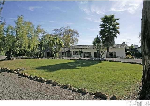 mediterranean / spanish-style house with a front yard and stucco siding