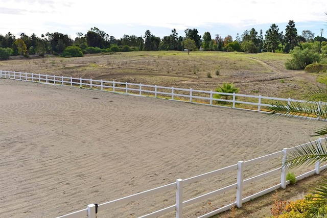 view of yard featuring a rural view and fence