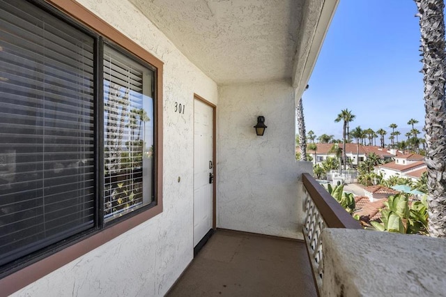 view of exterior entry with a balcony