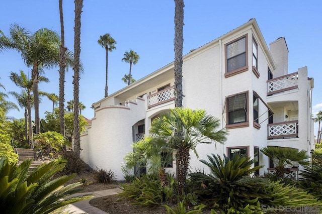 view of side of home with a balcony