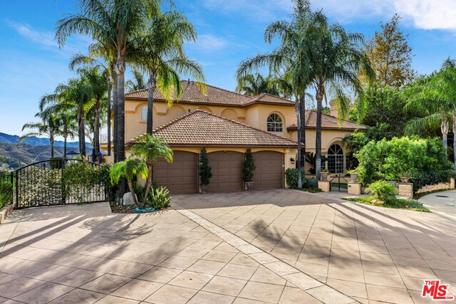 mediterranean / spanish house featuring a mountain view and a garage