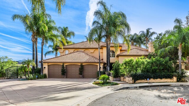 mediterranean / spanish home featuring a garage