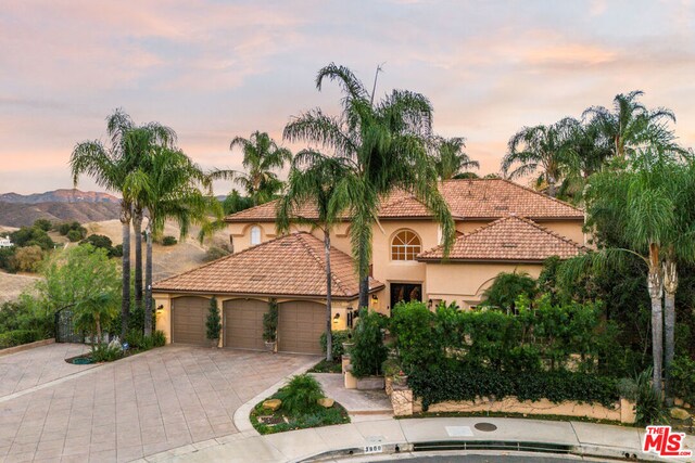 mediterranean / spanish-style house featuring a mountain view and a garage