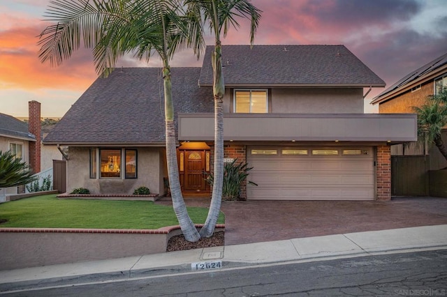 view of front of property with a yard and a garage