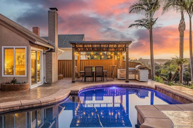 pool at dusk with a patio