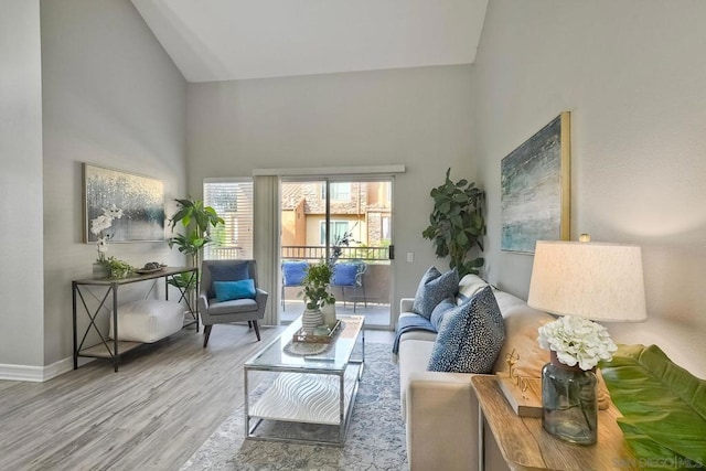 living room with vaulted ceiling and hardwood / wood-style flooring