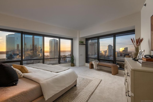 bedroom with light colored carpet and access to outside