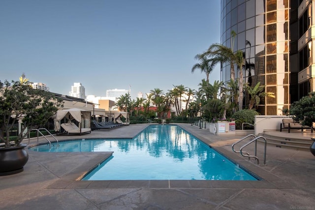 pool at dusk with a patio