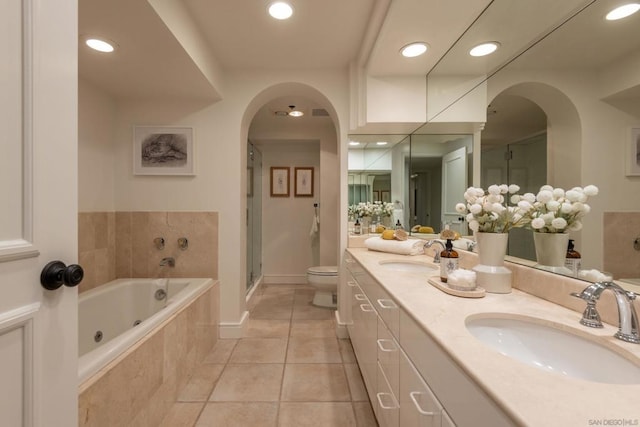 full bathroom with toilet, tile patterned flooring, shower with separate bathtub, and vanity