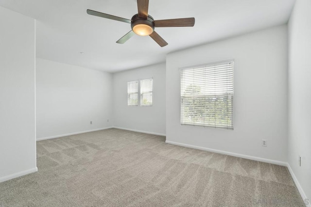 carpeted empty room featuring ceiling fan