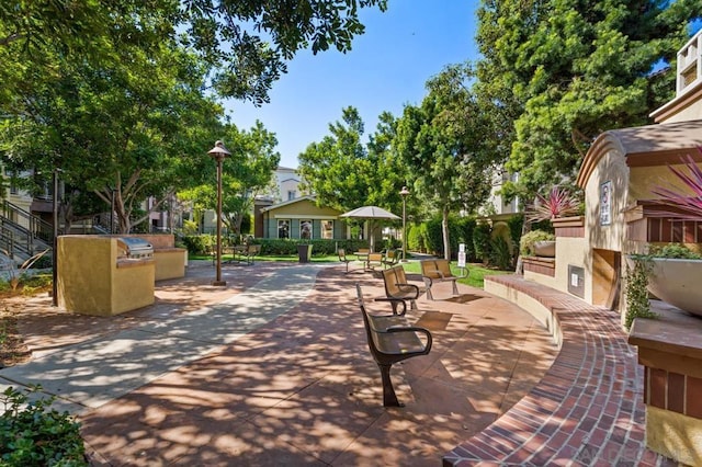 view of community with an outdoor kitchen and a patio