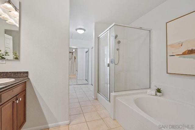 bathroom with tile patterned floors, vanity, and separate shower and tub