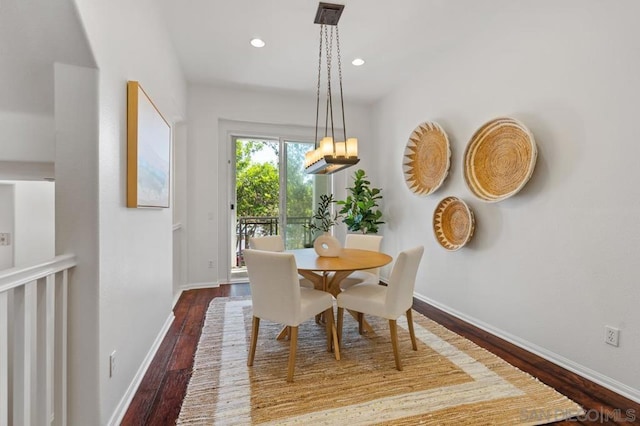 dining space with wood-type flooring