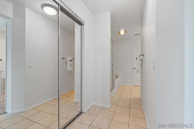 corridor with light tile patterned floors