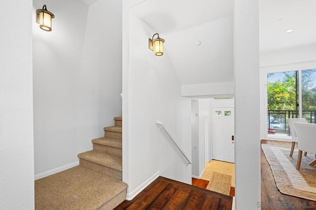 stairway with hardwood / wood-style flooring