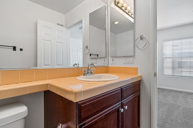 bathroom with toilet and vanity