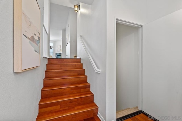 stairs with hardwood / wood-style floors