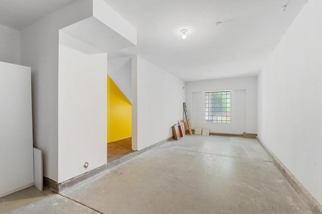 empty room with concrete flooring