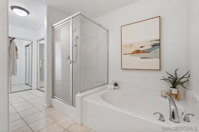 bathroom featuring tile patterned floors and separate shower and tub