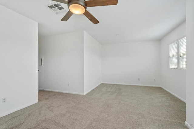 spare room featuring ceiling fan and light colored carpet