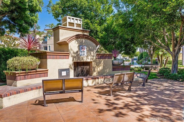 view of patio / terrace with exterior fireplace