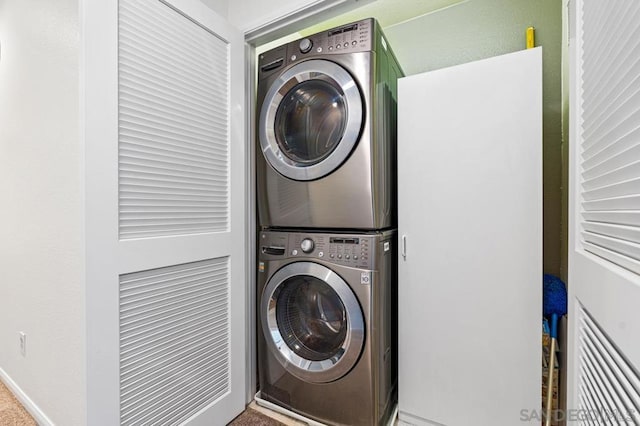 laundry room with stacked washing maching and dryer