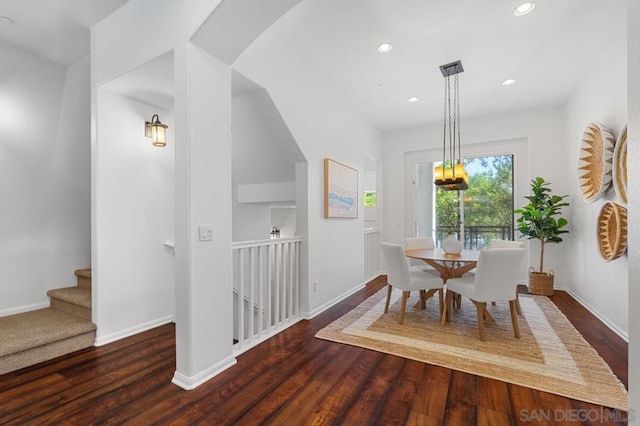 dining room with built in features and dark hardwood / wood-style floors