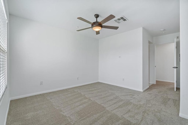 unfurnished room with ceiling fan and light colored carpet