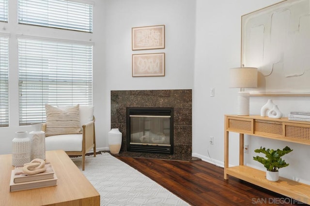 sitting room featuring dark hardwood / wood-style floors and a tile fireplace