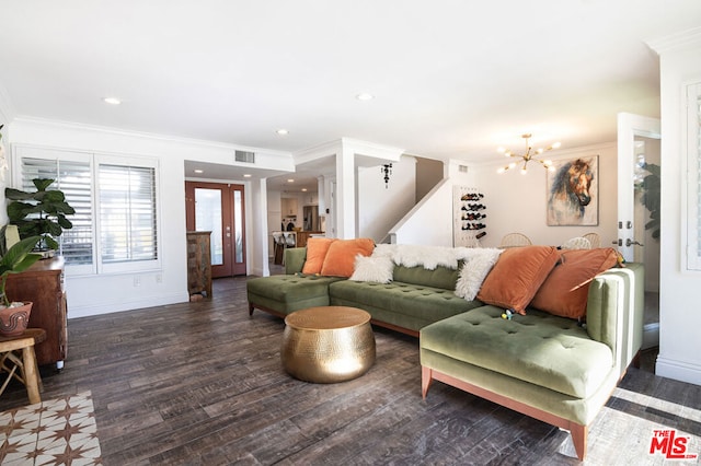 living room featuring french doors, dark wood-type flooring, ornamental molding, and a notable chandelier