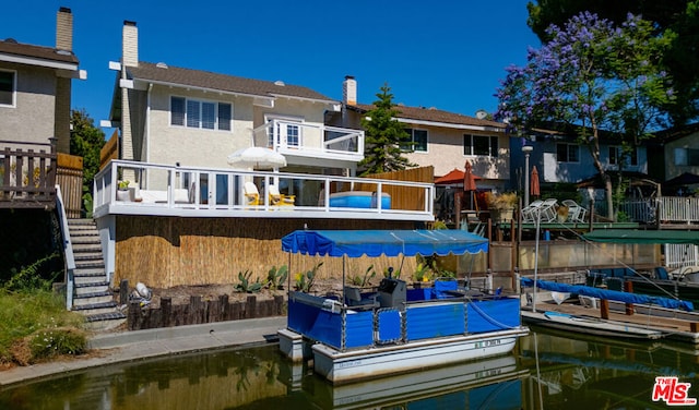 rear view of property featuring a water view