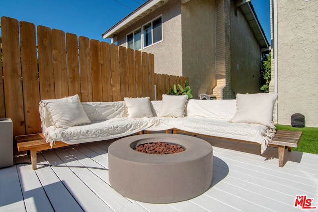 wooden terrace featuring a fire pit