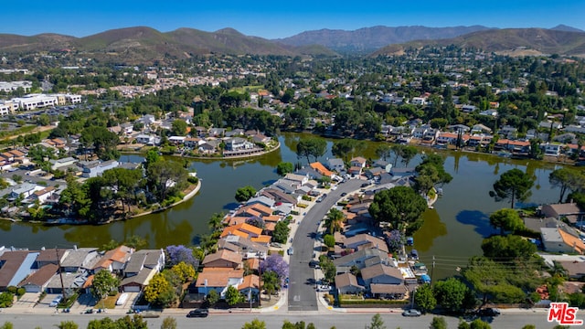 drone / aerial view with a water and mountain view